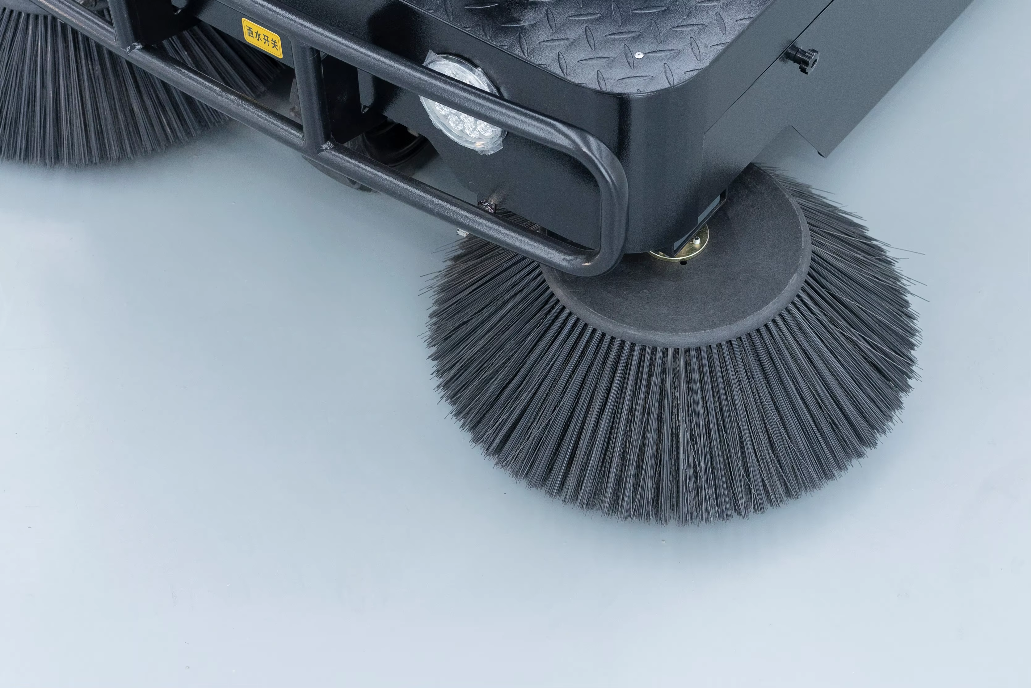 Ride-on sweeper brush
